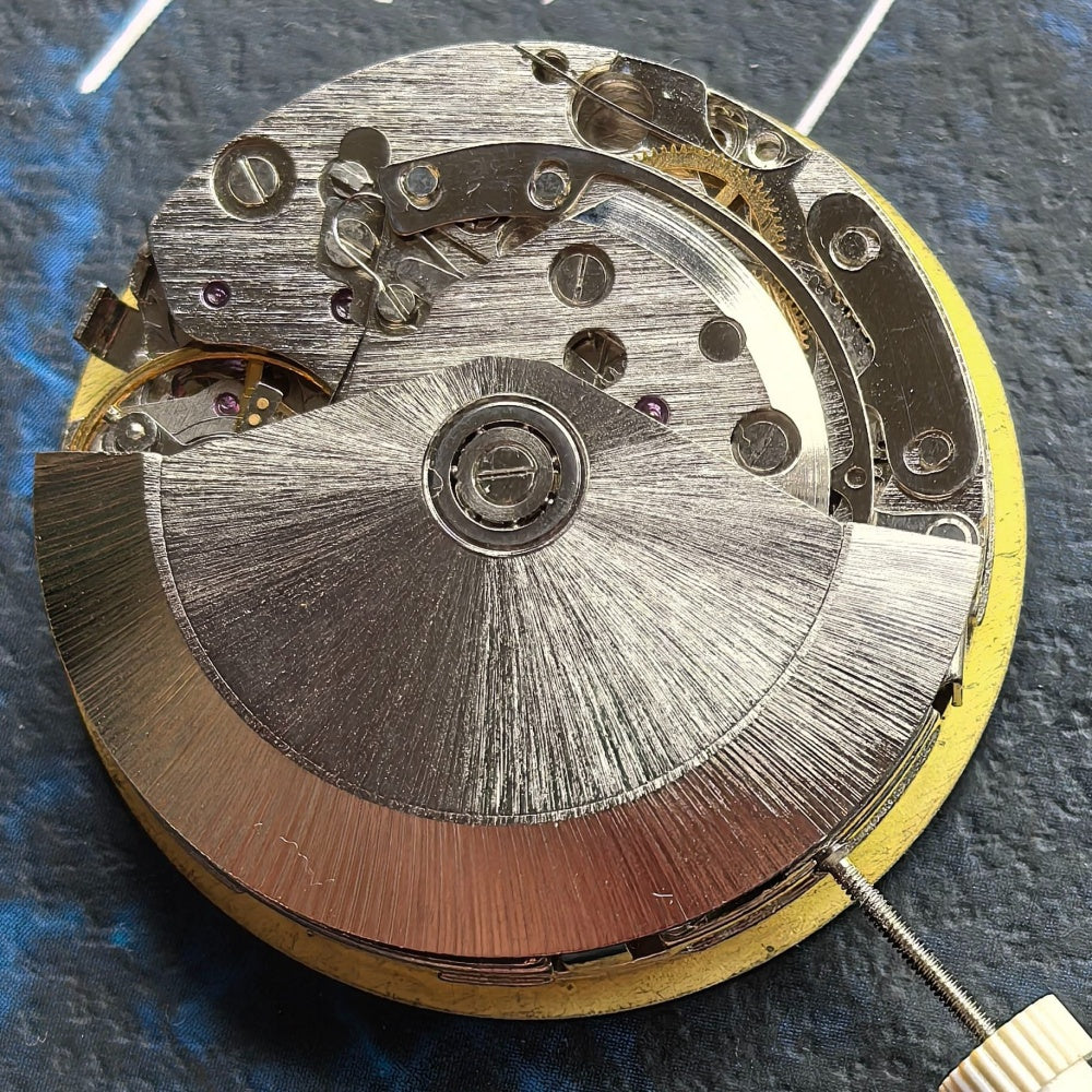 Chinese Dandong 7750 watch movement displaying big date at 12 and small seconds at 9, detailed close-up.