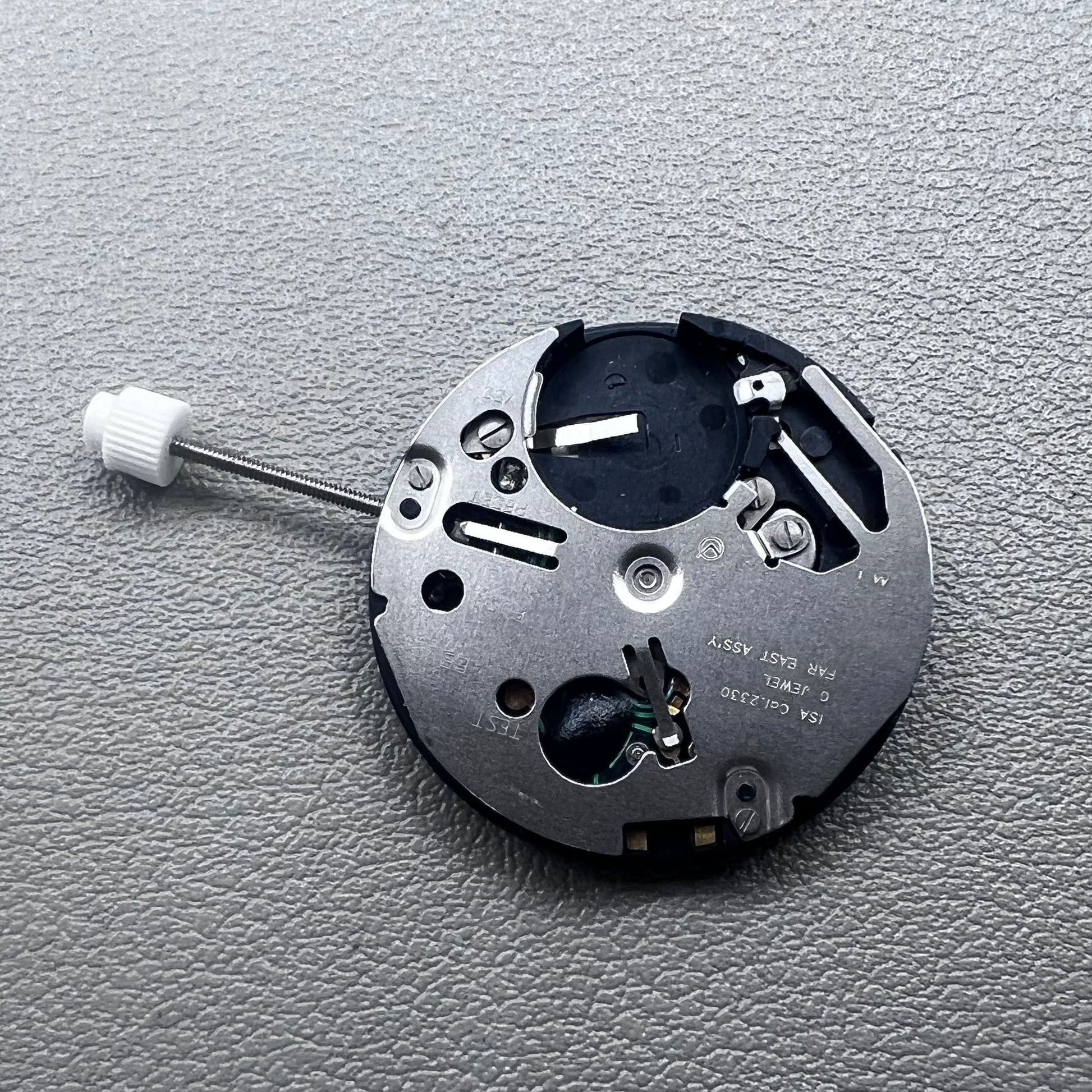 Swiss ISA 2330 quartz watch movement with black font date at 6 o'clock, precise 3-hand accessory.