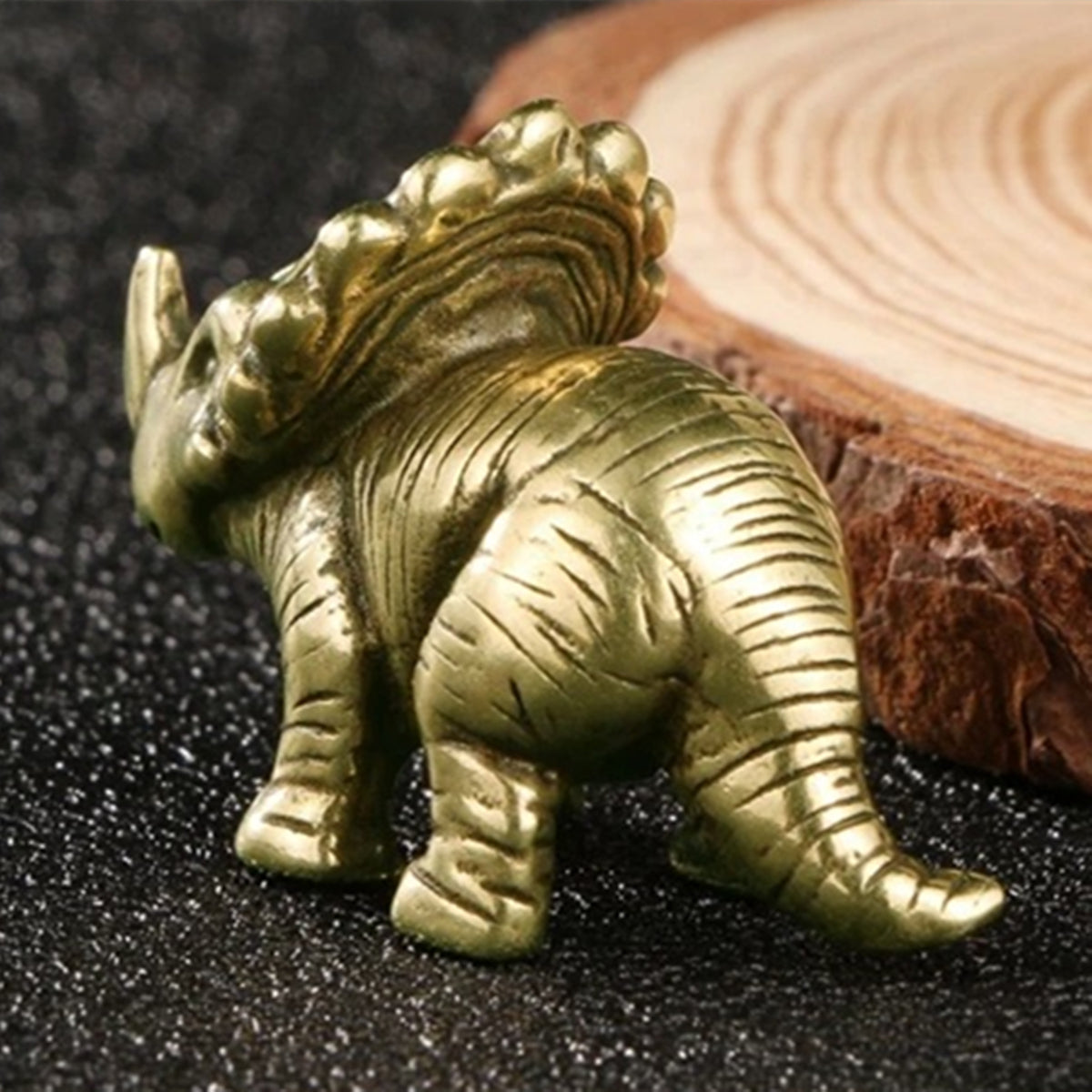 Hand-carved vintage copper horned dinosaur figurine, perfect for Jurassic-themed decor.