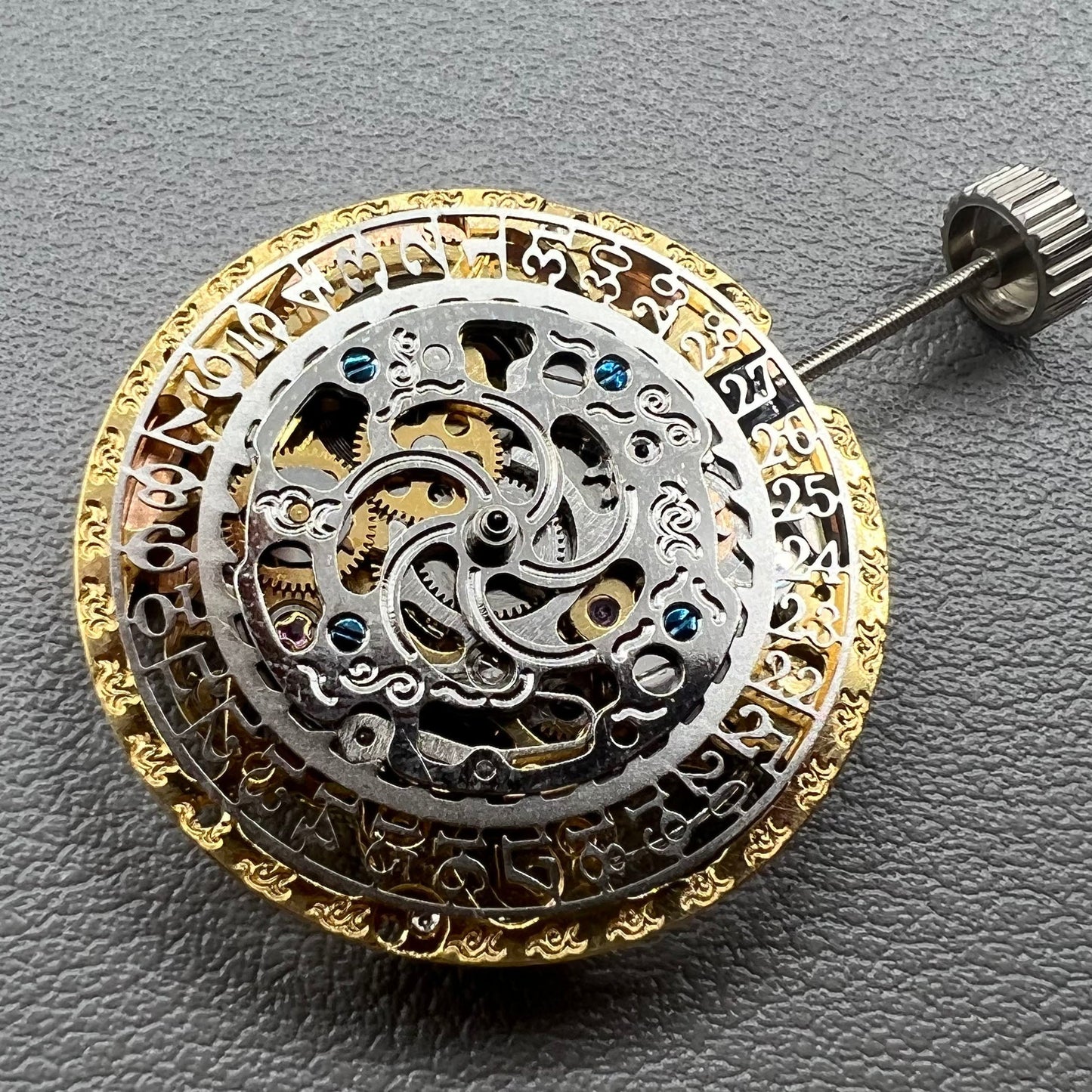 Golden Hangzhou 2189 mechanical calendar watch movement showcasing intricate hollow design and precise craftsmanship.