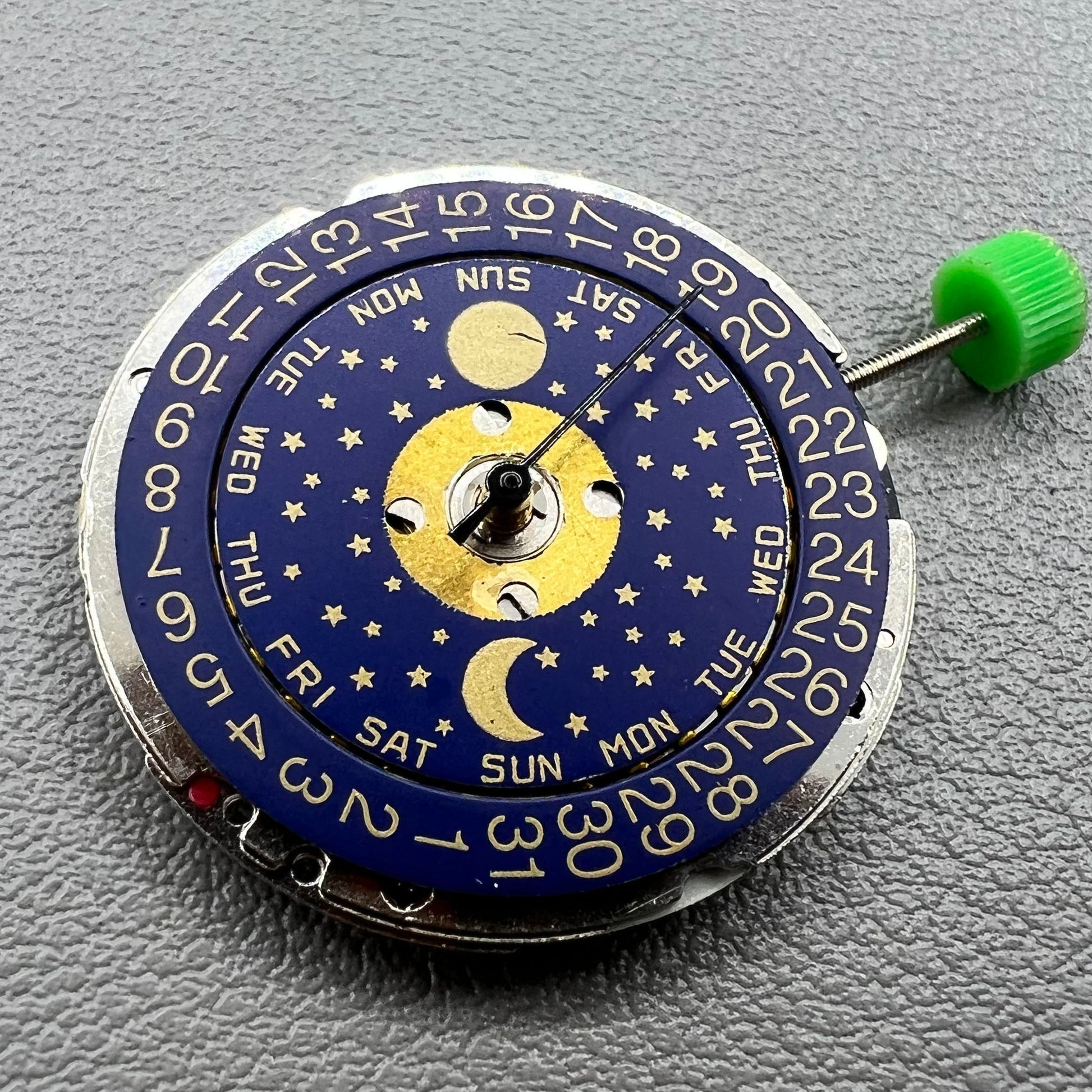 Swiss ISA 1198 quartz watch movement with day, date, and moon phase features for precise timekeeping.