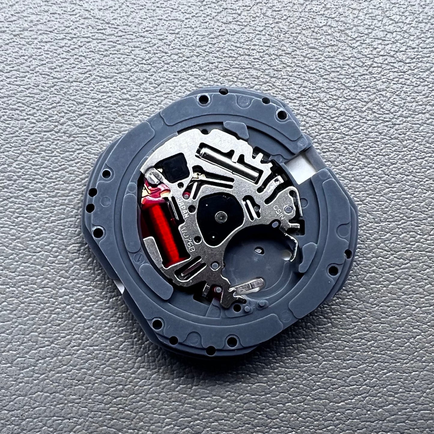 Japan Hattori VJ76B quartz watch movement with date display at 12 o'clock position, precise timekeeping.