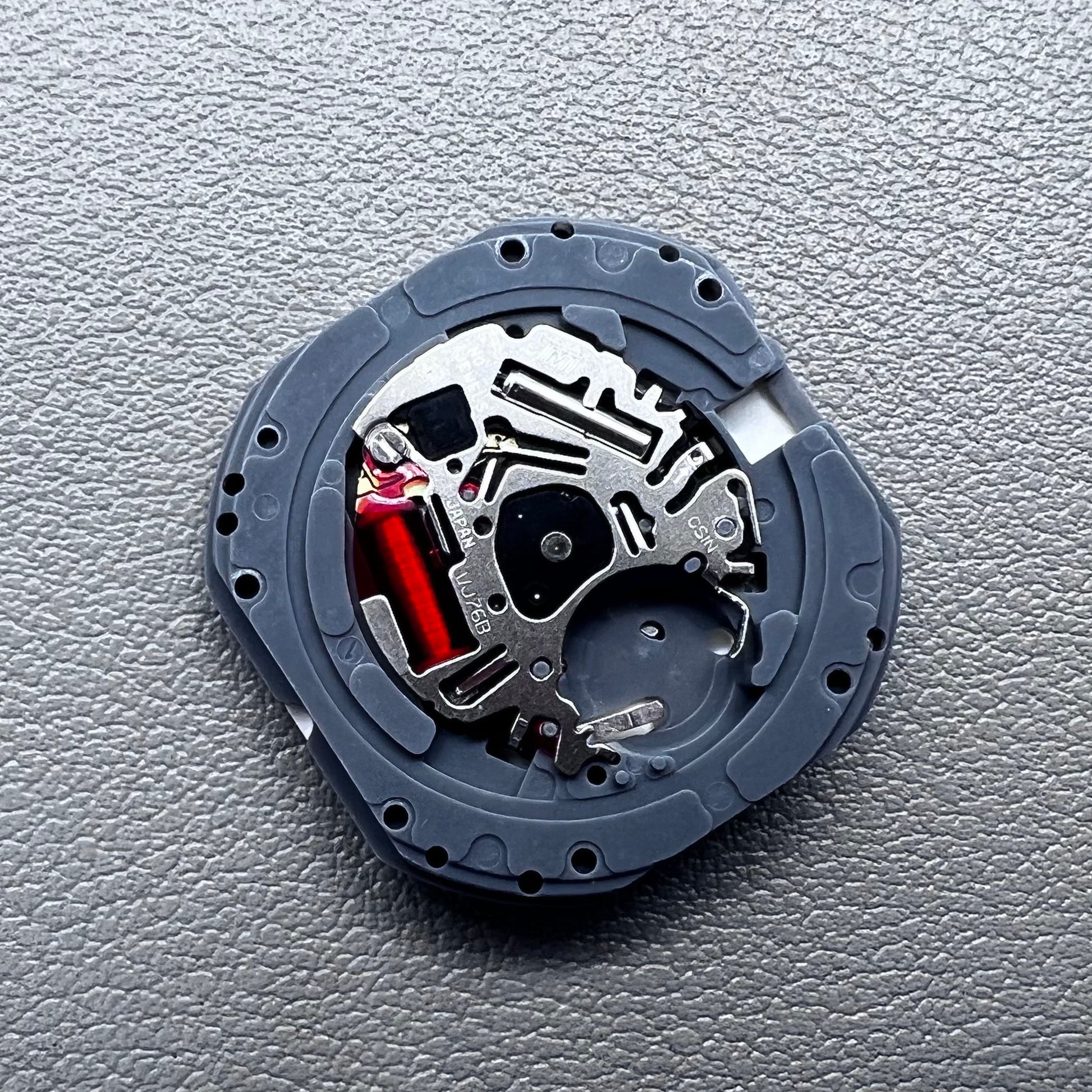 Japan Hattori VJ76B quartz watch movement with date display at 12 o'clock position, precise timekeeping.
