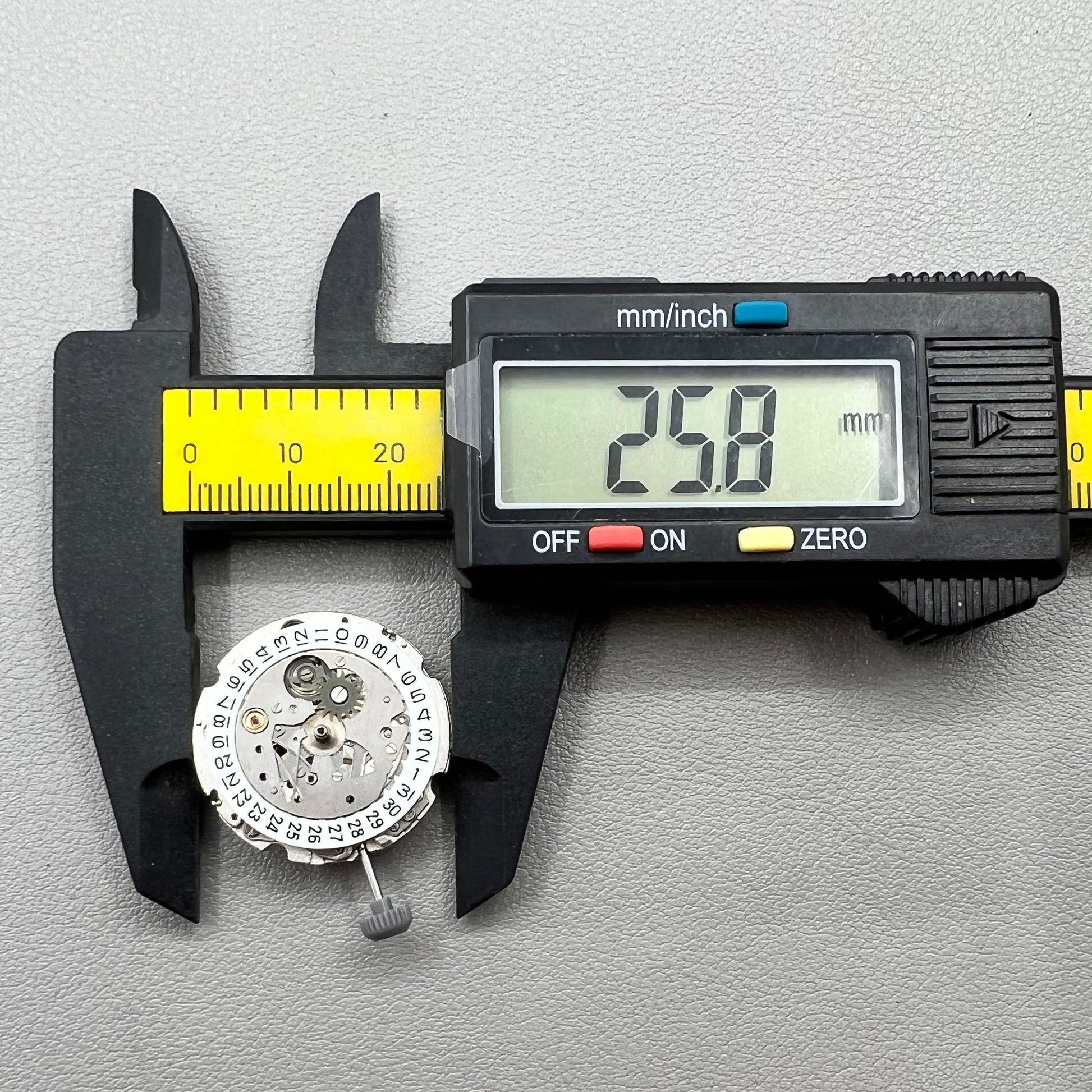 Close-up of Japan Miyota 8200 movement with single date display at 3 o'clock on watch accessory.