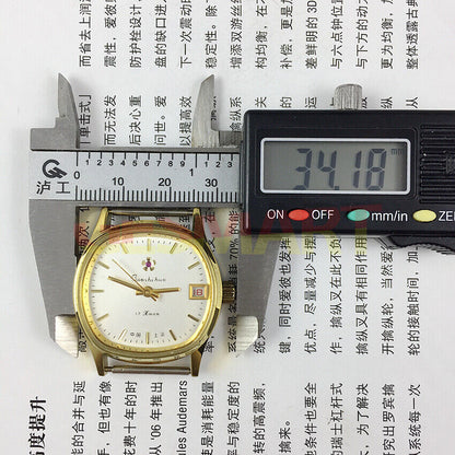 33mm Shanghai manual watch with white dial, golden nail markers, single calendar, elegant design.