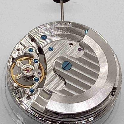 Silver mechanical flywheel watch part, precision movement component for watch repair and assembly.