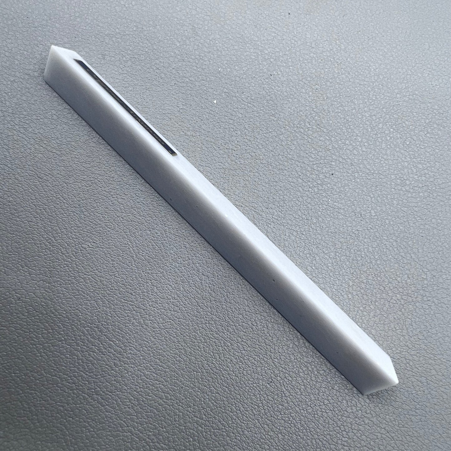 Horotec MSA16.013 Arkansas triangular sharpening stone for precise watch tool maintenance and polishing.