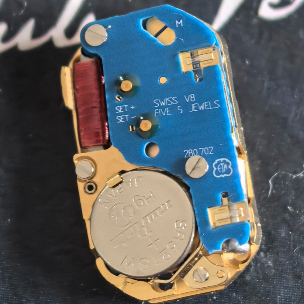 Close-up of Swiss Made ETA280.702 quartz movement watch part for accurate timekeeping.