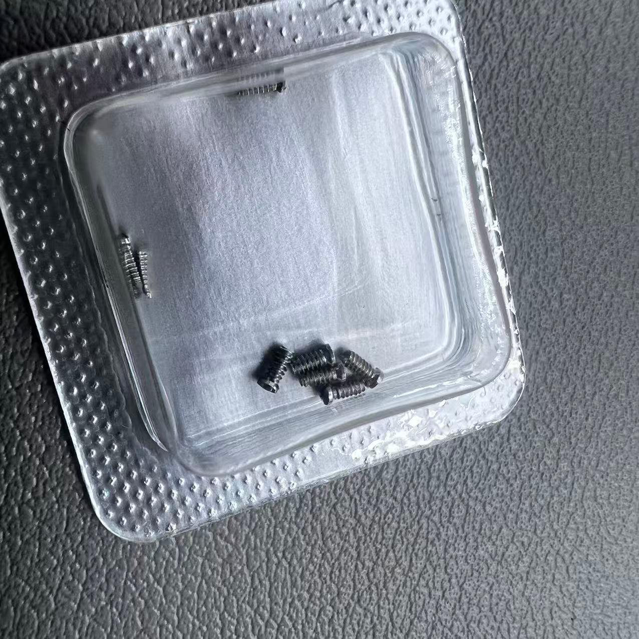 Silver 2.5x1mm slotted watch back cover screws for Cartier women's watches, durable replacement parts.