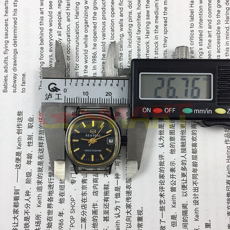 Seagull 26mm black case lady watch with gold markers, manual mechanical movement, and calendar display.