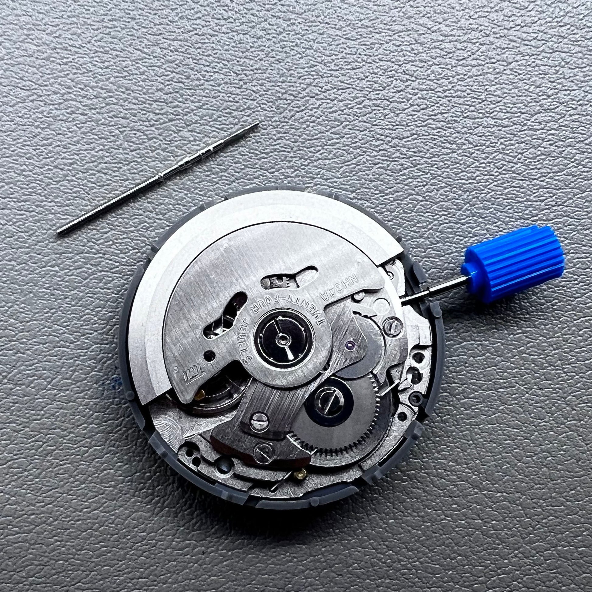 Seiko NH34 mechanical GMT watch movement with blue disk and white font for accurate timekeeping.