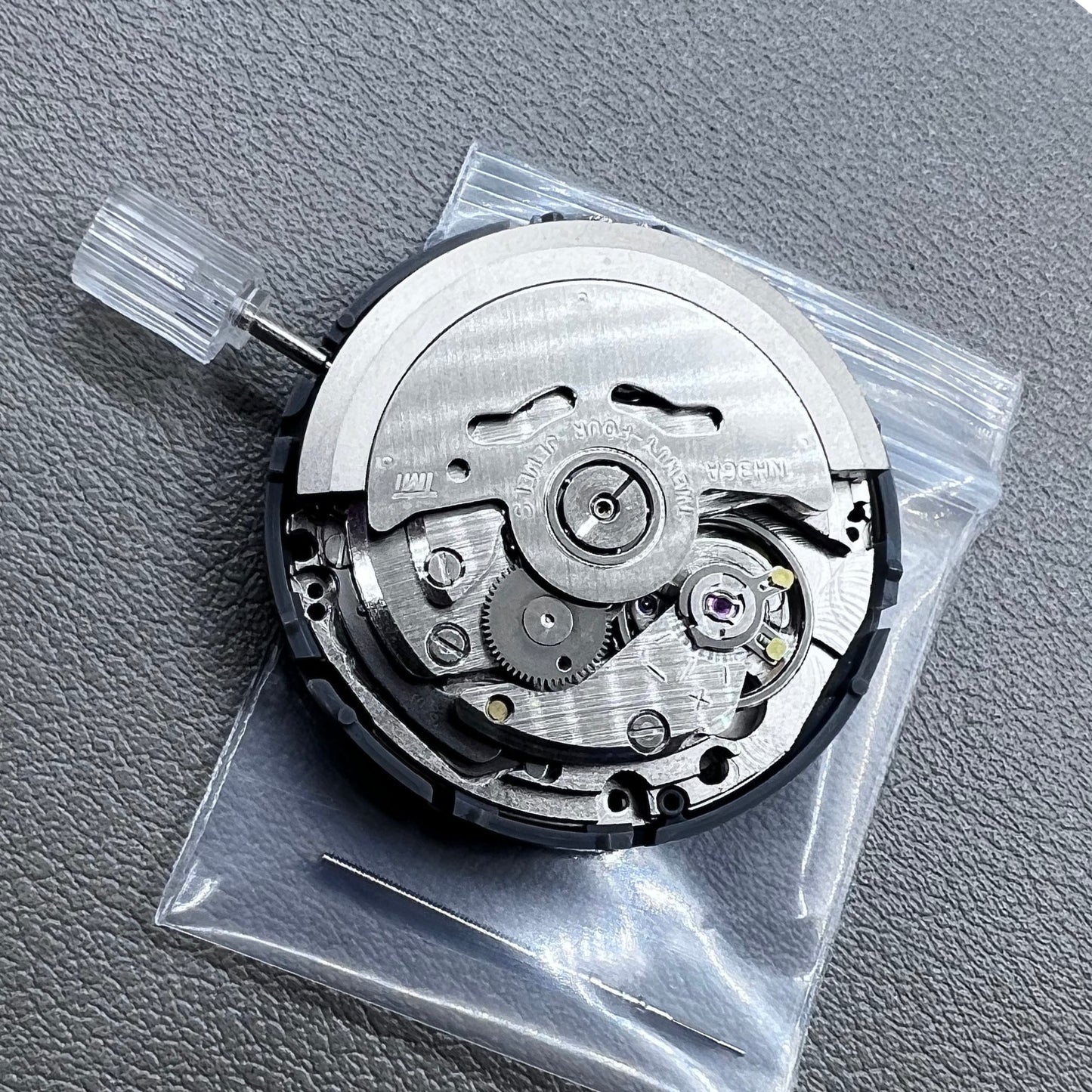 Seiko NH36 watch movement with black dial, Arabic numerals, date display, crown at 3:00 position