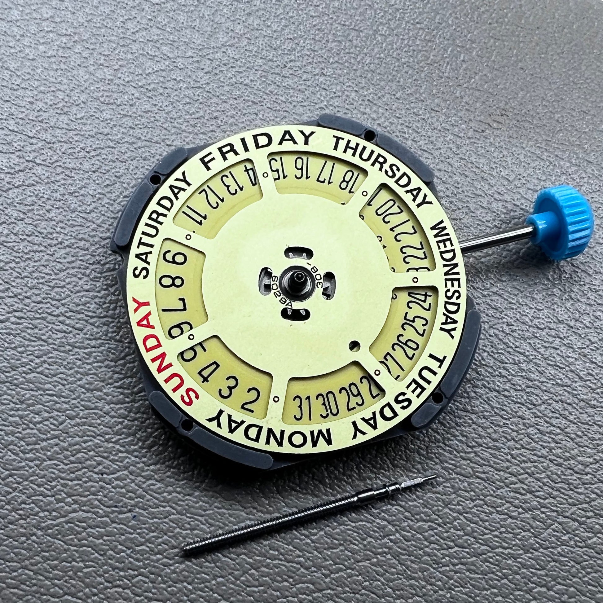 Japan Miyota 6M50 Quartz watch movement with golden dial, date at 6 o'clock, 3 hands, precise timekeeping.