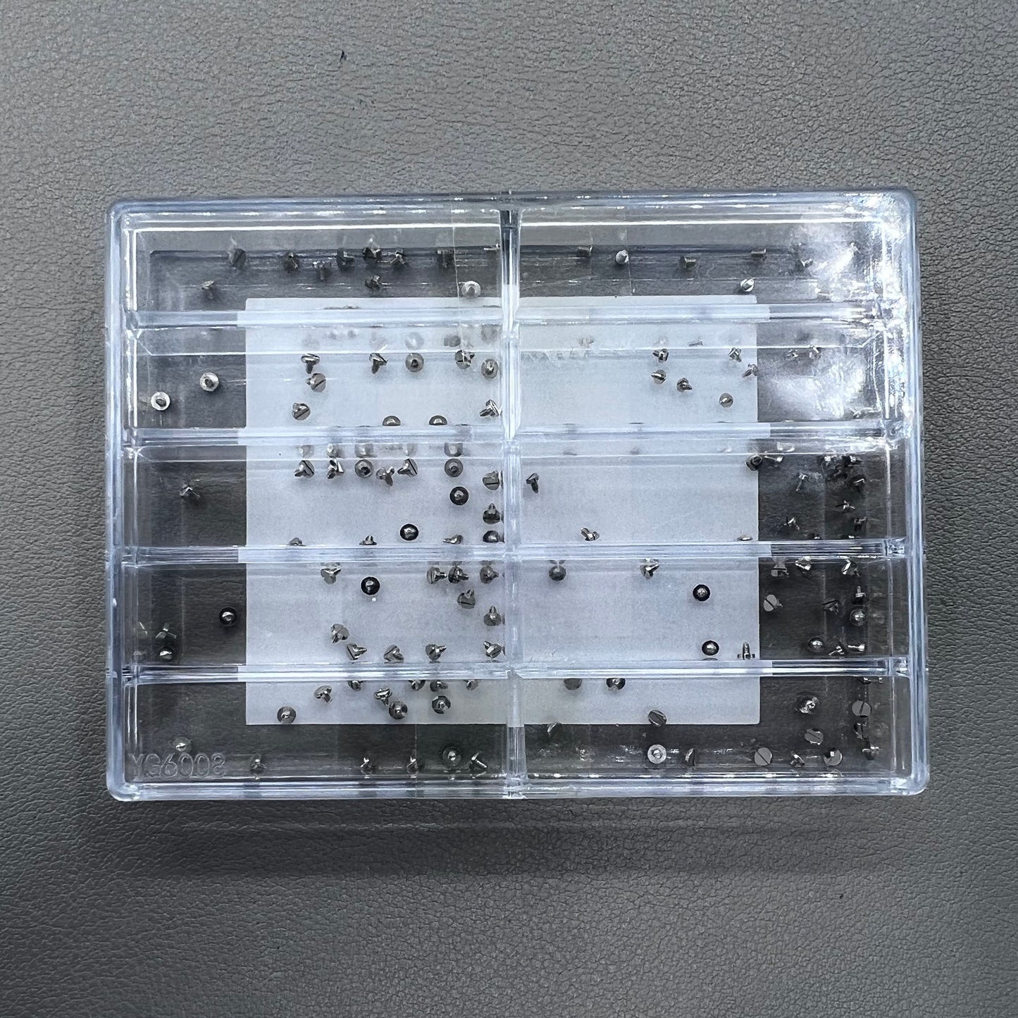 Replacement fixing screws for watch movements in assorted sizes, durable precision.