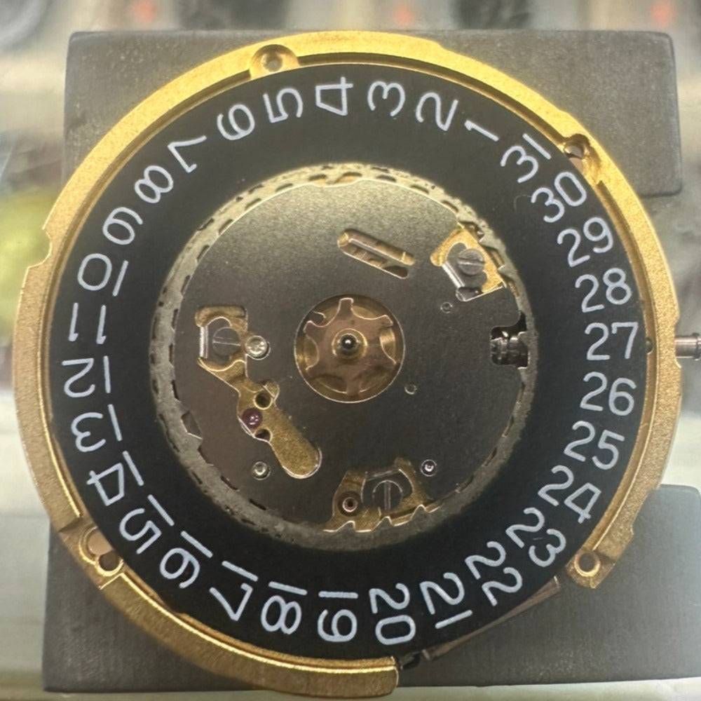 Swiss Made Ronda 6003.D quartz watch movement with single calendar, black disk, and 3 hands.