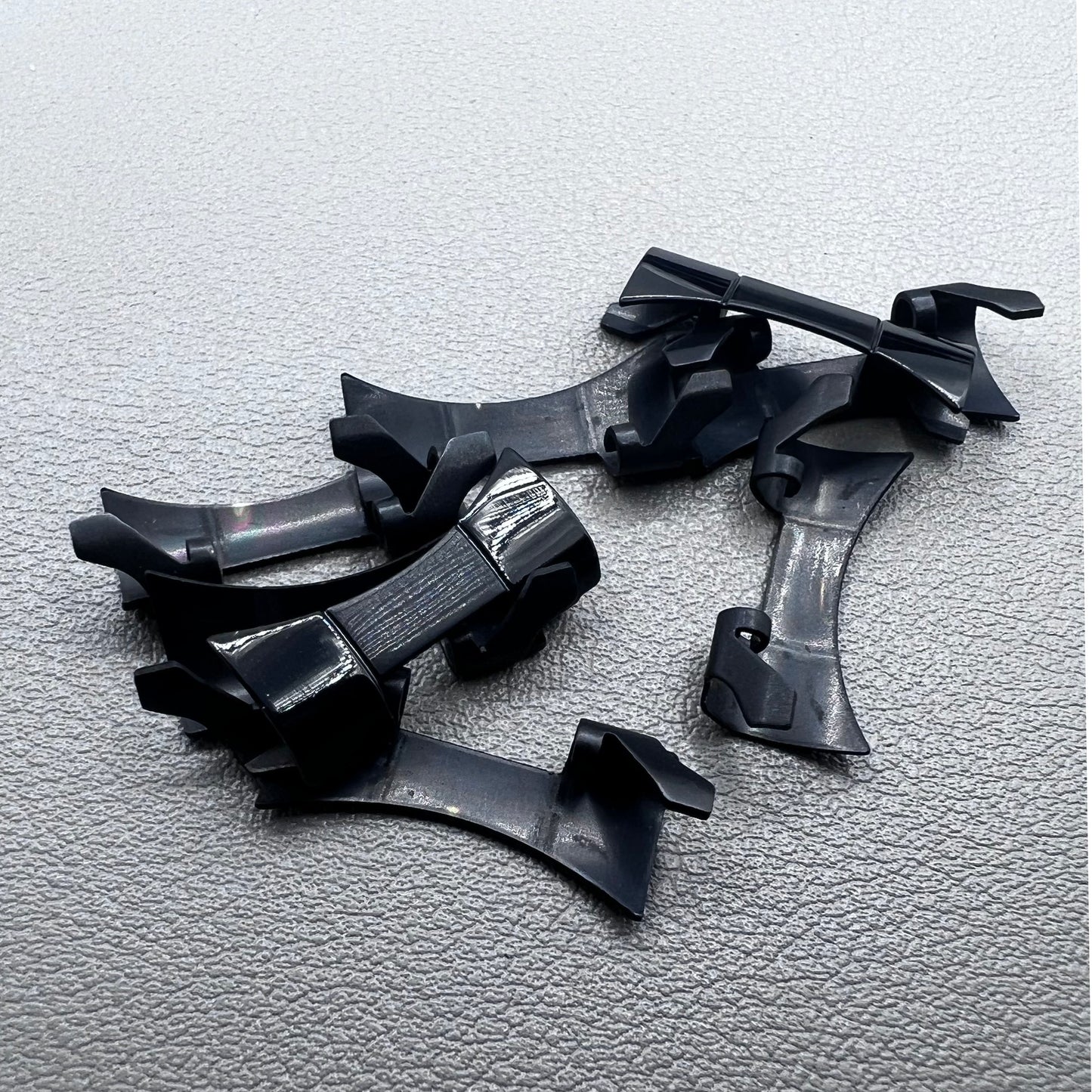 1. Six steel black matte curved end links with spring bars for durable watch band straps.  