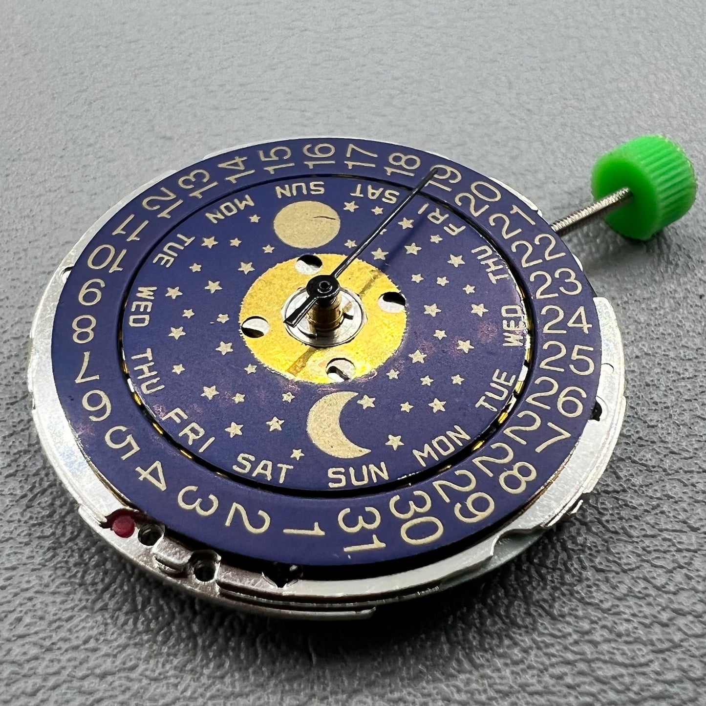 Swiss ISA 1198 quartz watch movement with day, date, and moon phase features for precise timekeeping.