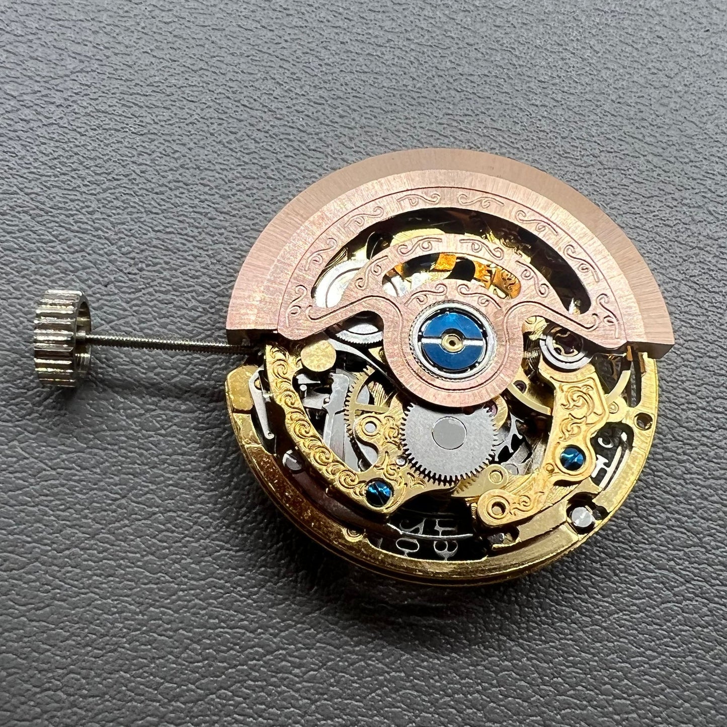 Golden Hangzhou 2189 mechanical calendar watch movement showcasing intricate hollow design and precise craftsmanship.