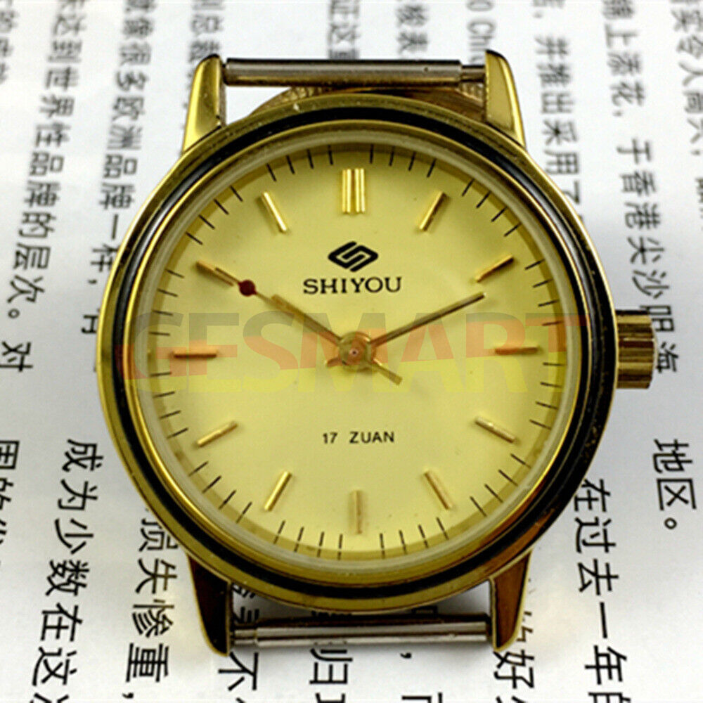 34mm China made manual mechanical watch with 17 jewels, golden dial, and round golden case.