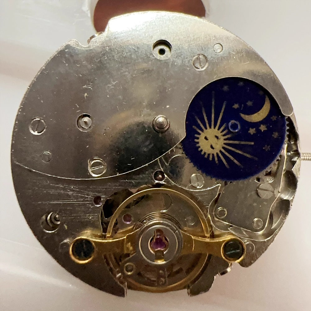 China Made 7120 mechanical watch movement showing moon phase, date at 3, balance wheel at 6.