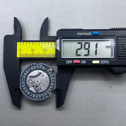 Japan Seiko VK63 quartz watch movement with black disk and white font for precise timekeeping.