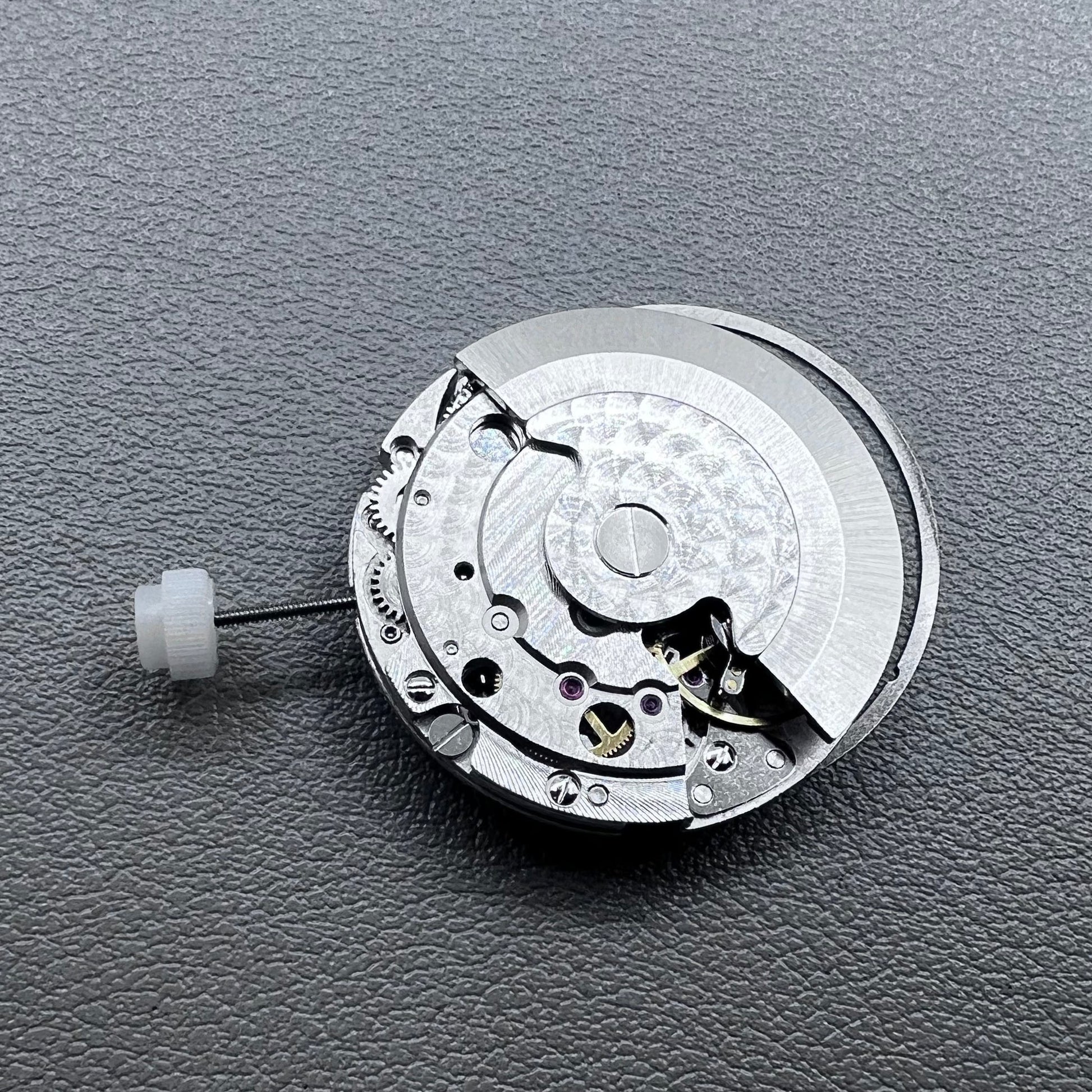 Silver plated DG2813 automatic watch movement with large and small hands, date display at 3 o'clock