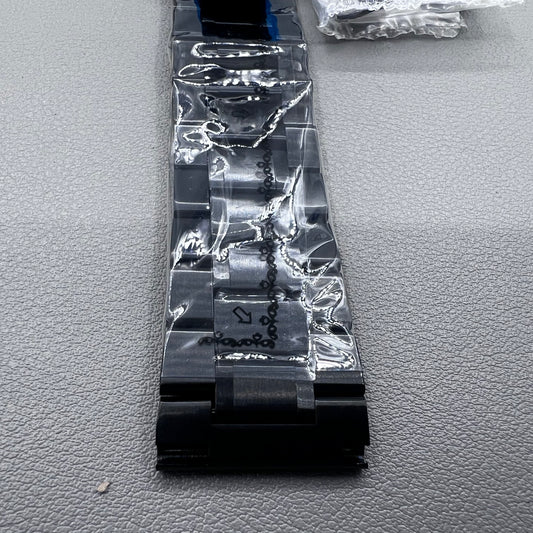 Curved end black steel 23mm watch band with butterfly clasp, durable and stylish.