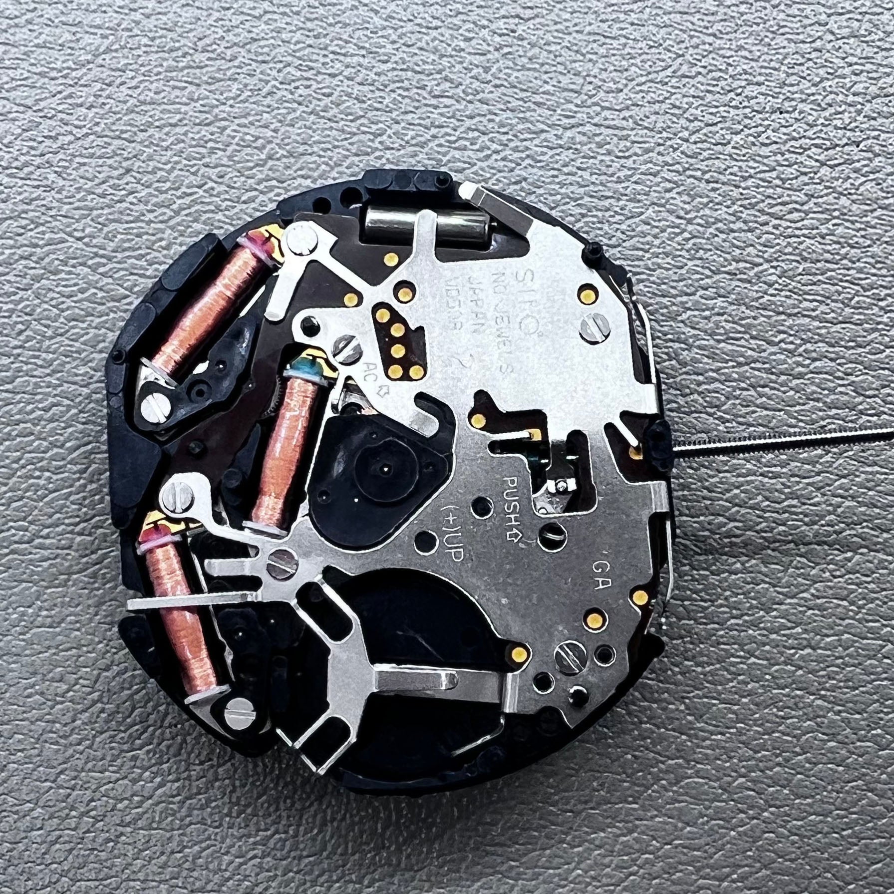 Original Japan VD59 watch movement close-up showing multifunctional quartz small second at 6/9/12 o'clock positions.