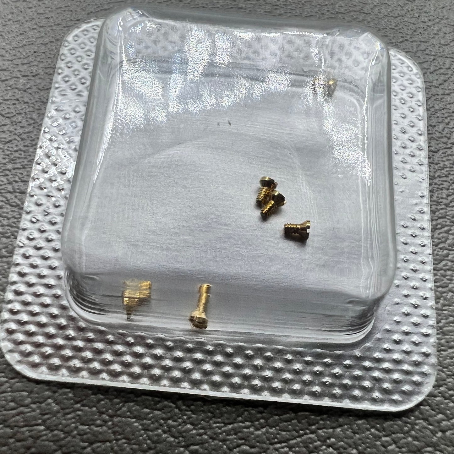 Set of 6 L4.209.4 watch case back screws, 1.2�0.7�1.7mm, for precise watch repair and maintenance.