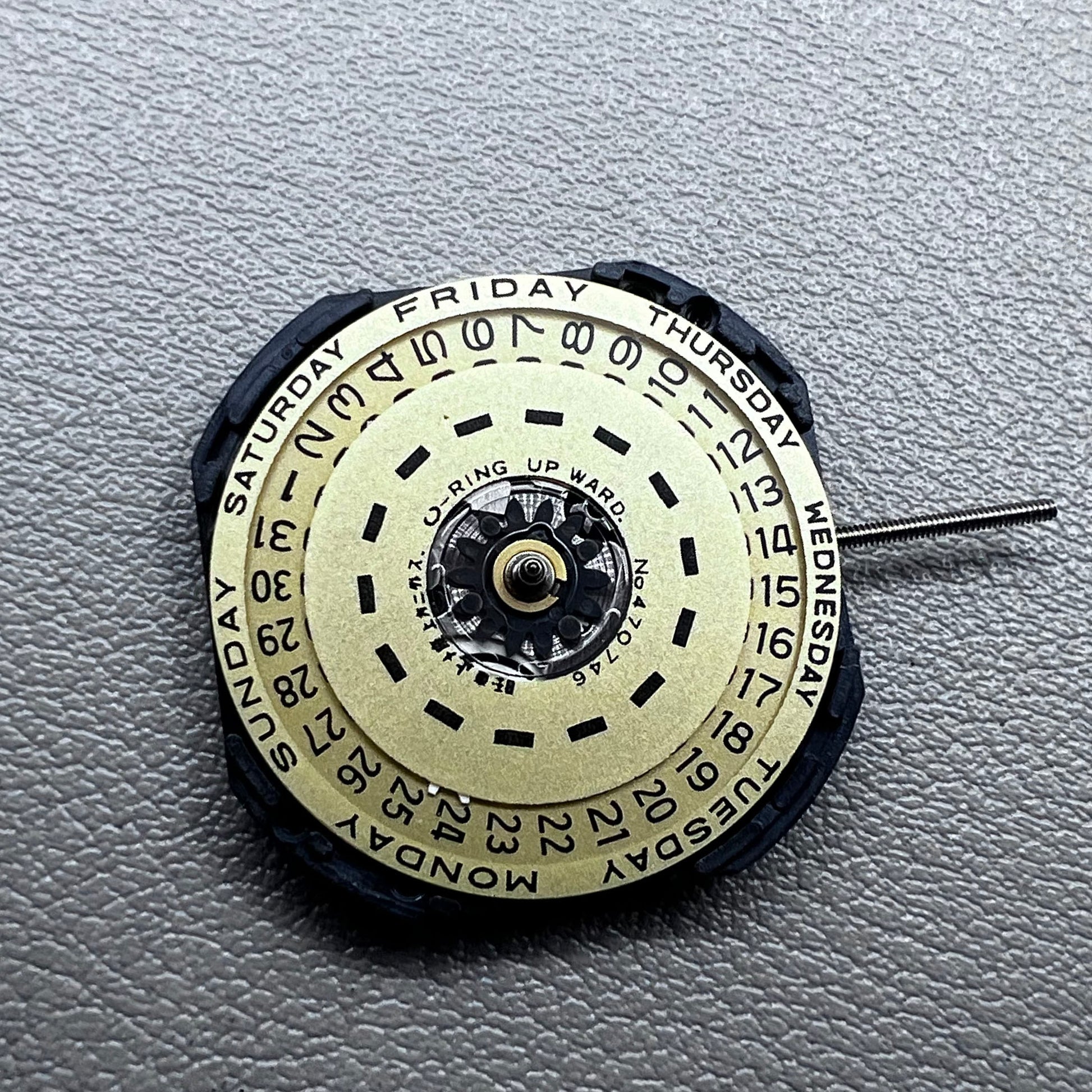 Japan Yl44A quartz watch movement with 3 hands, double calendar, and golden disk detail.