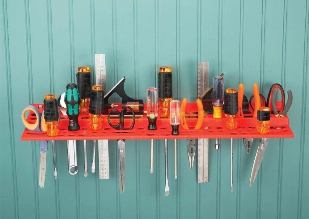 Wall-mounted hardware board with screwdriver and pliers storage for organized tool hanging.