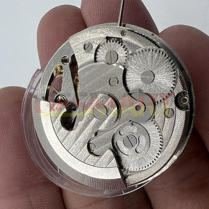 Silver automatic mechanical watch featuring three hands and a hollow moon phase at 12 o'clock.