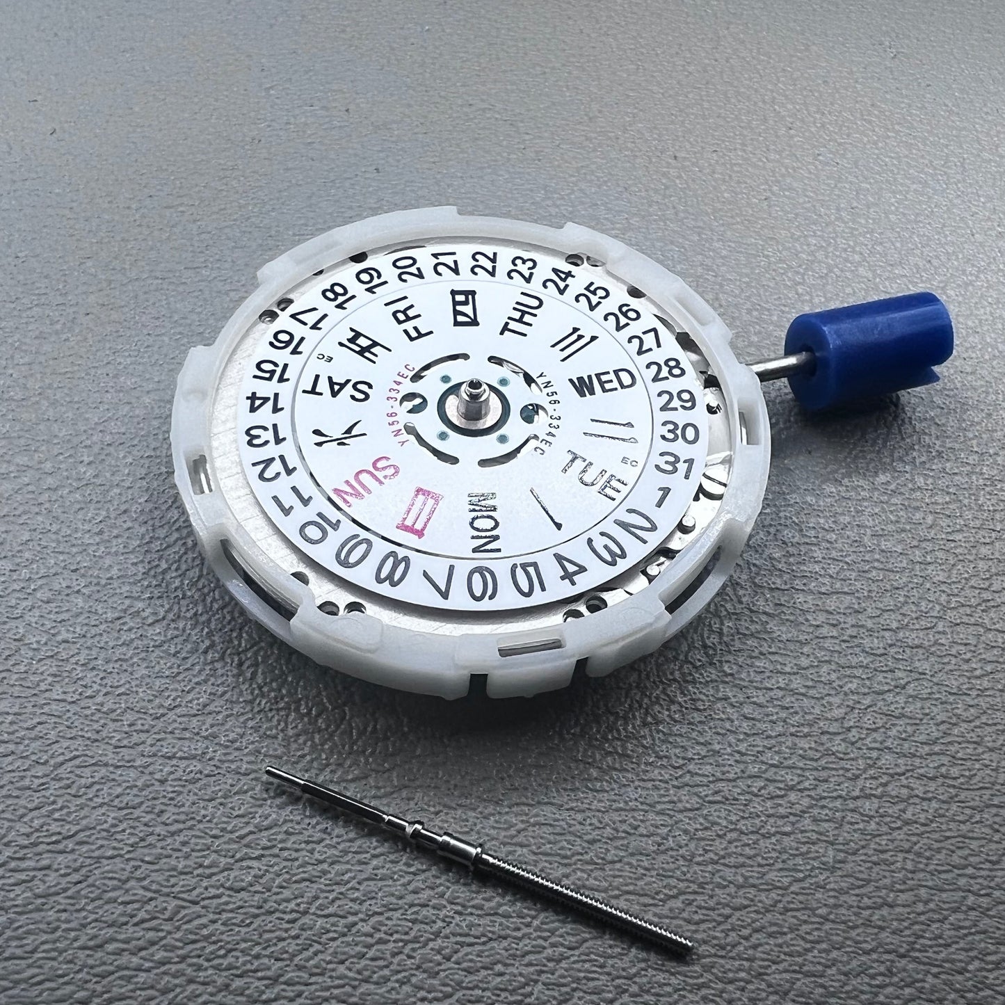 Japan Epson YN56 mechanical watch movement showing date and day display at 3 o'clock, precise and reliable.