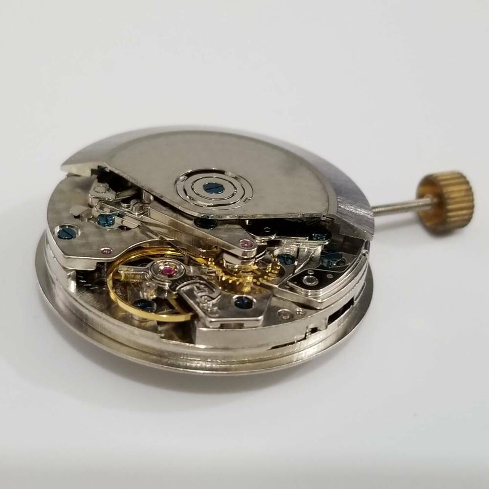 DANDONG 7750 automatic watch movement showing white day-date display for precise time repairs.