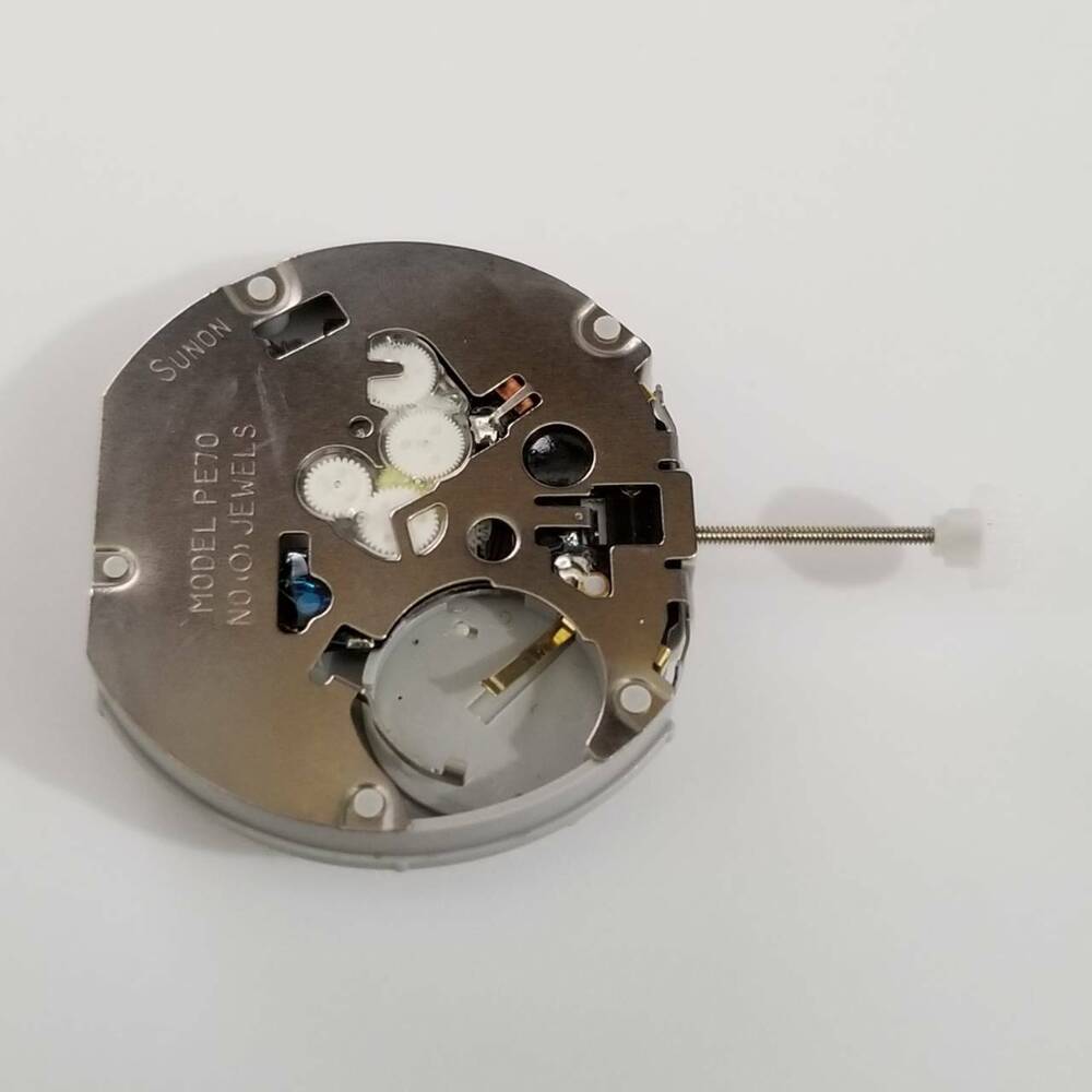 SUNON PE70-2 quartz watch movement repair part showing intricate gears for accurate timekeeping.