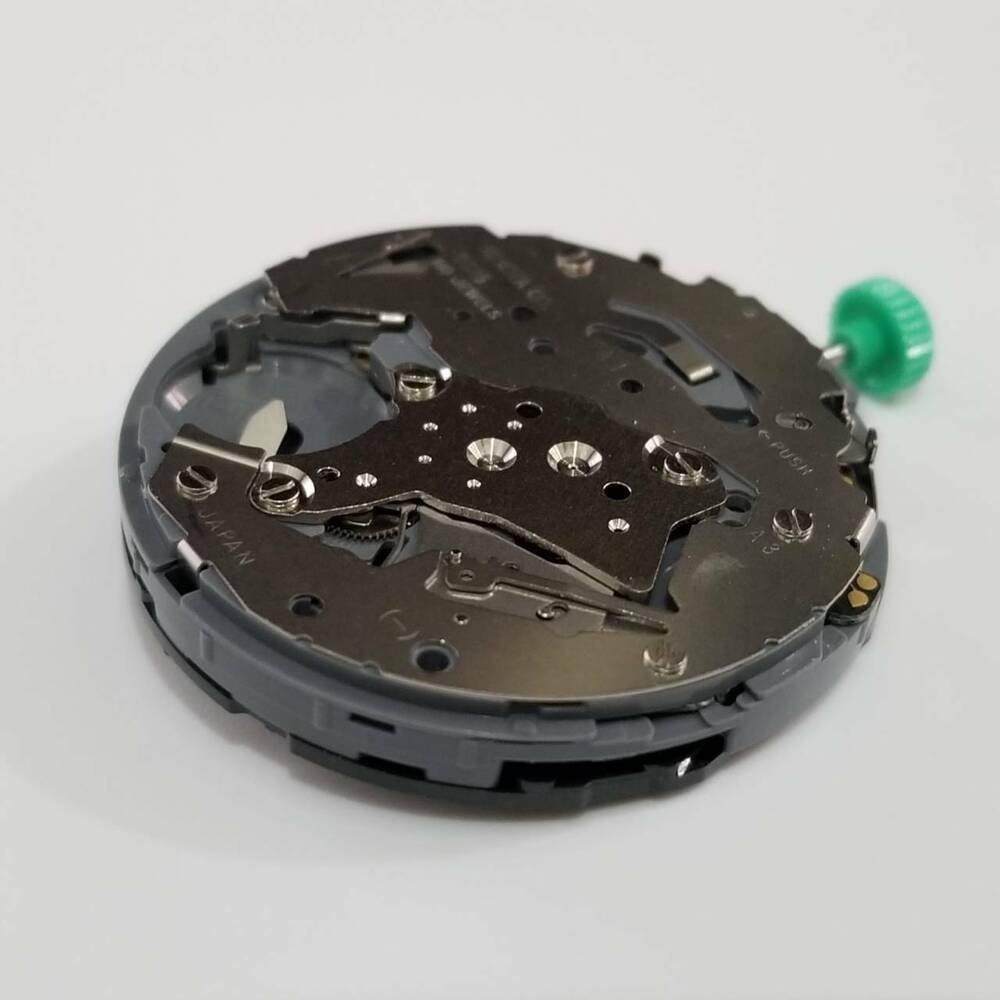 Miyota OS25 quartz watch movement by Citizen, precise timekeeping repair part for watches.