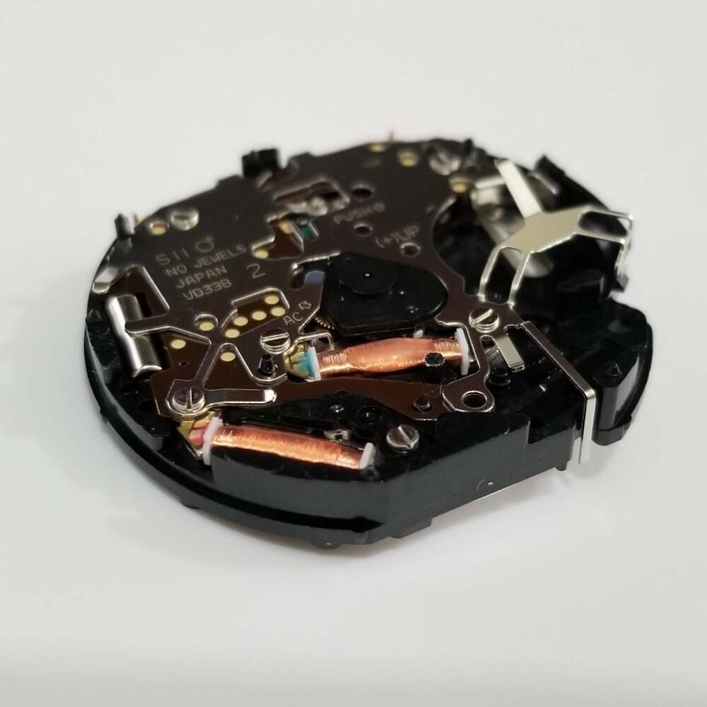 Hattori Epson VD33 quartz watch movement, Japan-made repair part ensuring precise and reliable timekeeping.