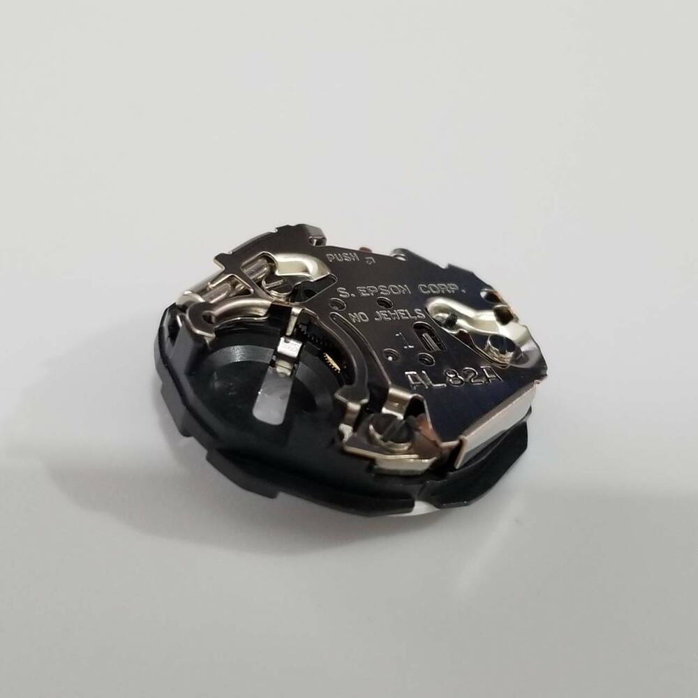 S. Epson AL82 quartz watch repair part showing precise gear mechanism for accurate timekeeping.