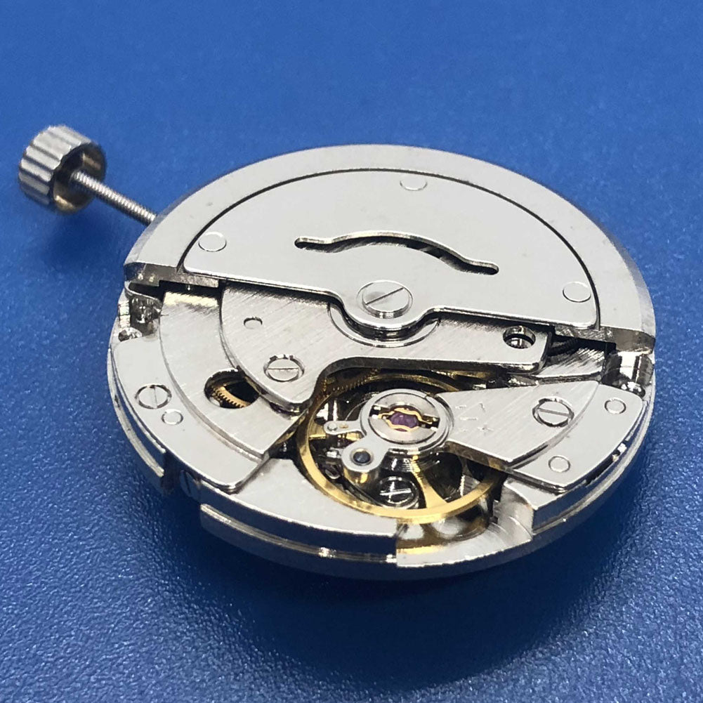 DG2813 silver watch movement featuring 3 hands and single calendar, precise mechanical component for watch repairs.