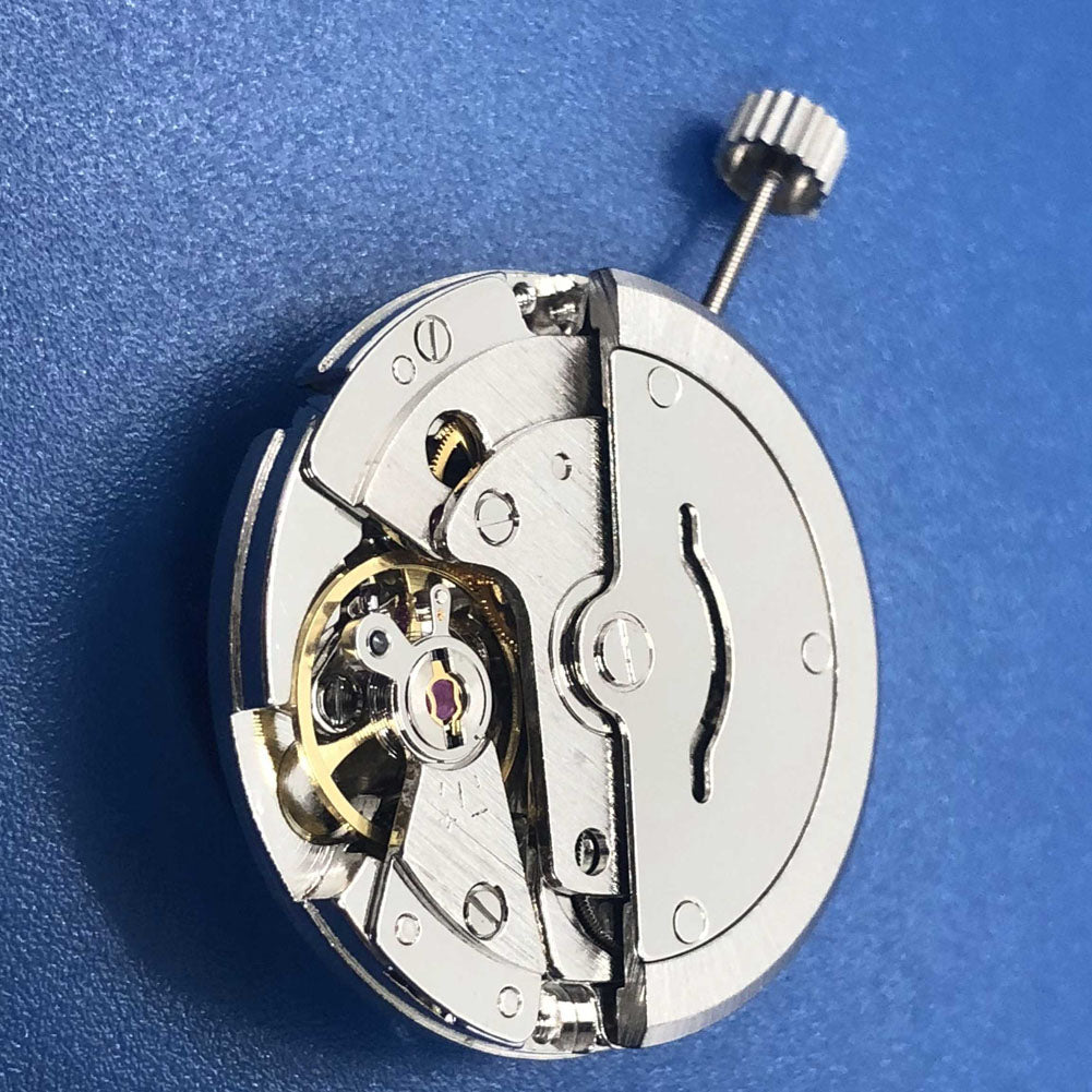 Tian Jing DG2813 automatic watch with silver case, day-date display, and precise mechanical movement.