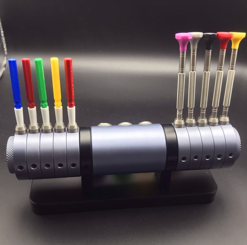 7011 watch repair tool set with screwdrivers, oiler, and alloy stand for precise maintenance.