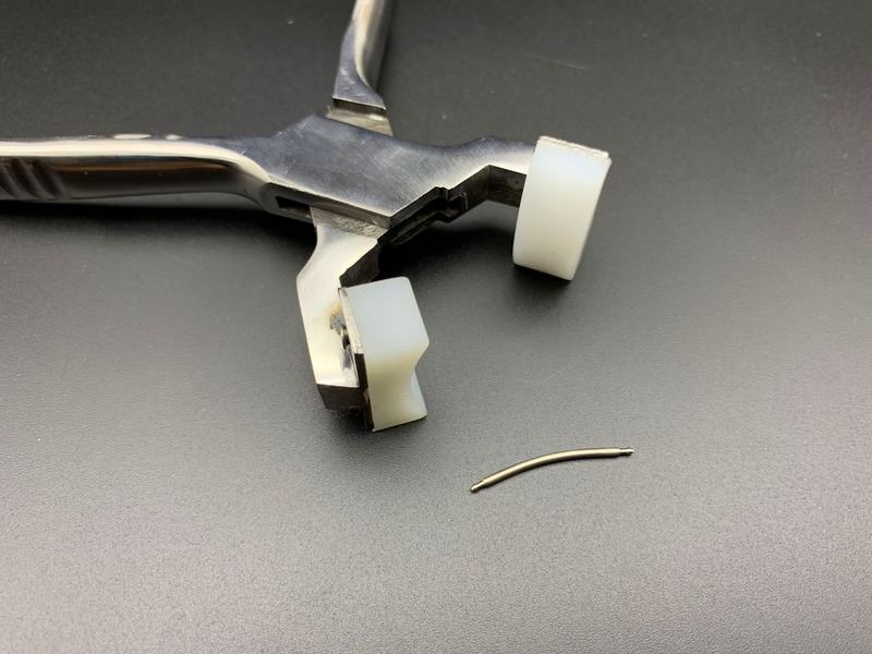 Spring shaft pliers for precise watchband adjustment with steel bracelet and connecting ear rod.