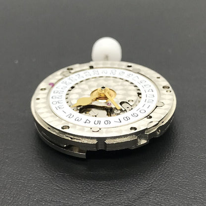 China Made 3186 Automatic GMT watch movement featuring engraved blue balance spring, showcasing precision engineering.