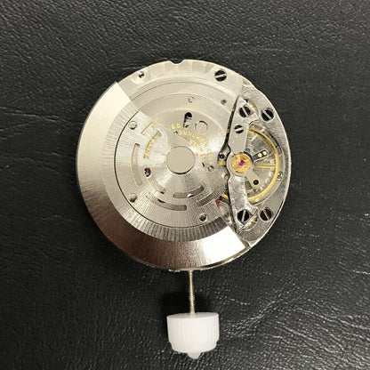 Close-up of China Made 3186 Automatic GMT watch movement featuring engraved blue balance spring and precision craftsmanship.