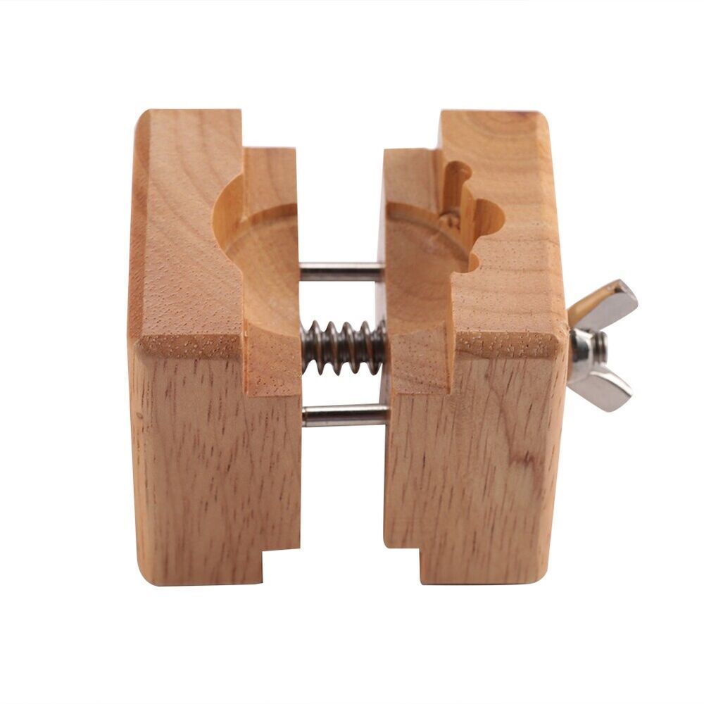 Wooden watch case holder block for secure watch repair and maintenance.