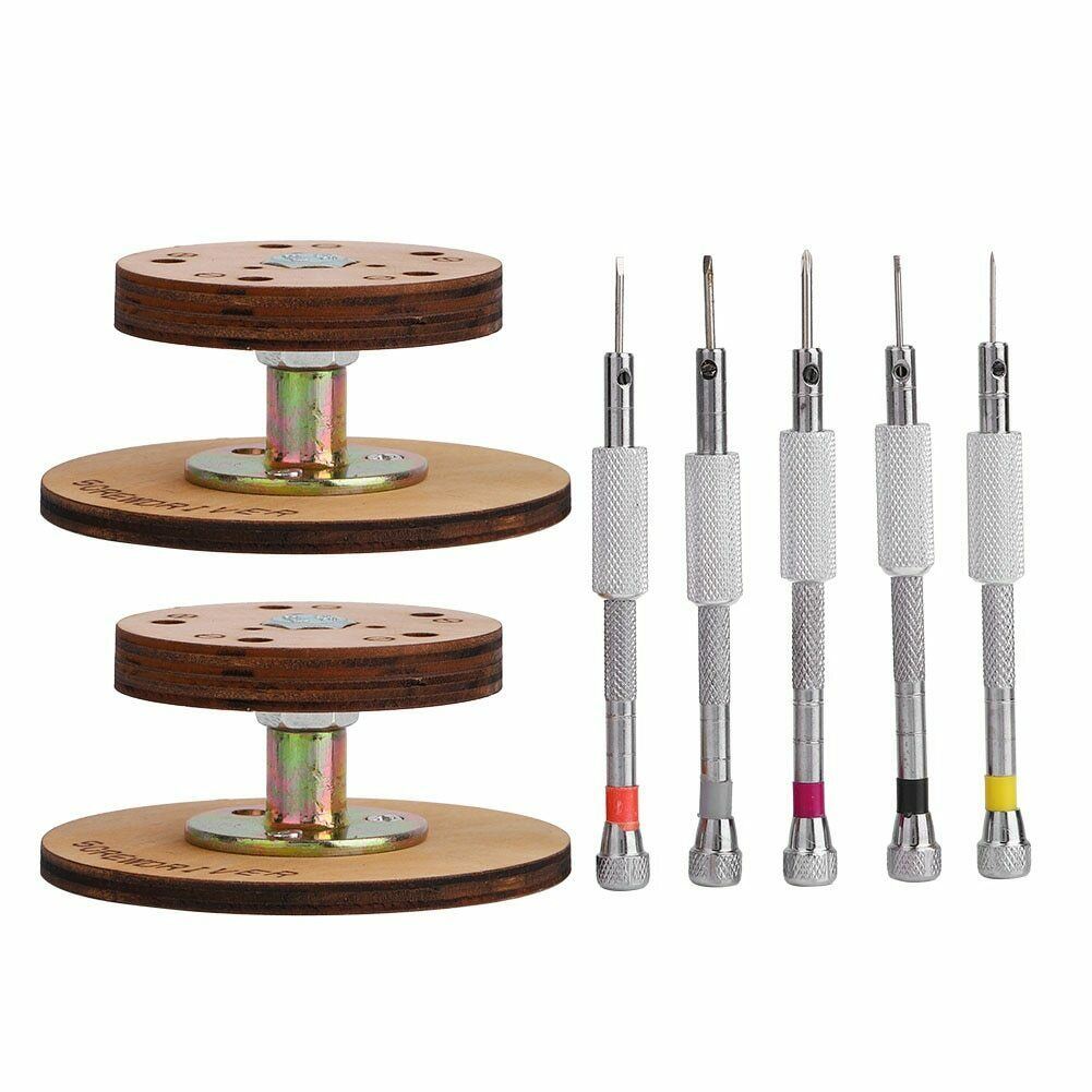 Set of 5 steel watchmaker screwdrivers on a rotary stand for precise watch repairs.