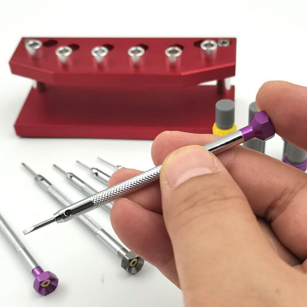Precision watch screwdriver set with extra blades and stand for watch repair and maintenance.