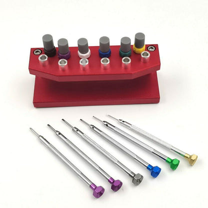 Precision watch screwdriver set with extra blades and stand for watch repair.