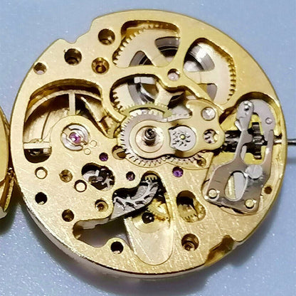 Golden 26.5mm 7120 automatic mechanical watch movement with intricate hollow design.