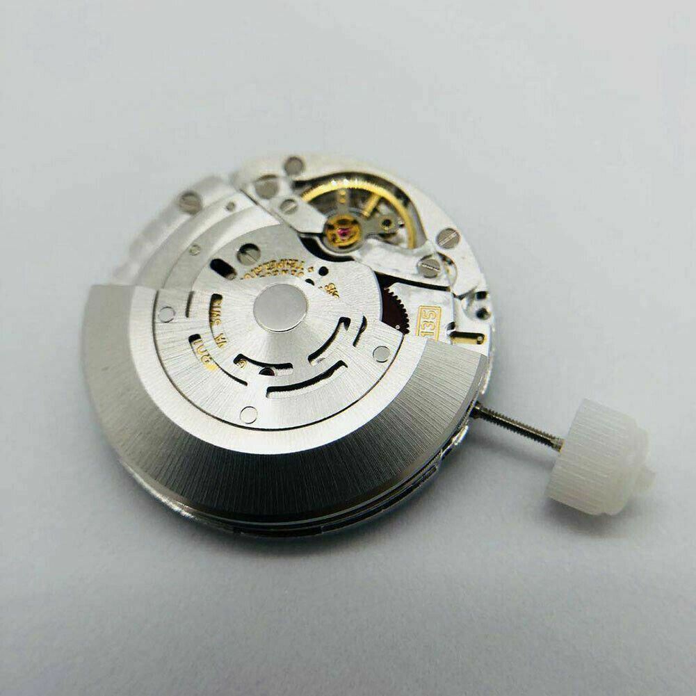 SH3135 watch movement with detailed engraving and blue balance spring, highlighting precision craftsmanship.